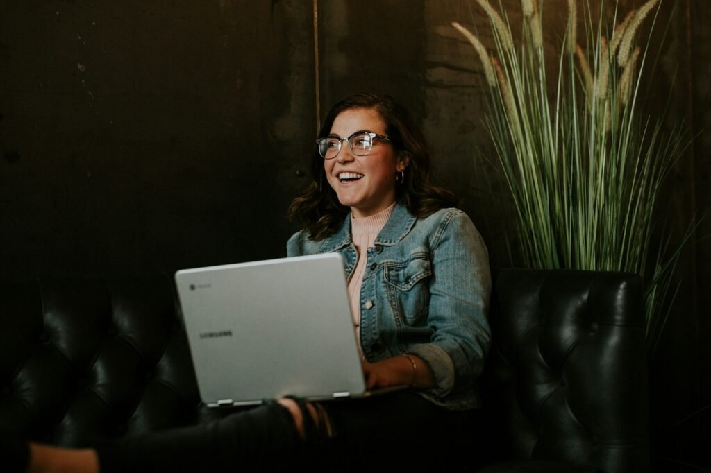 Woman using a silver laptop on her lap