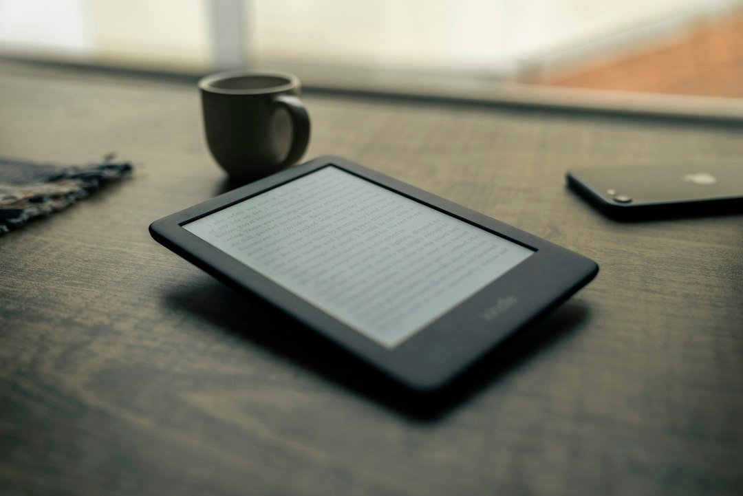 Reading device beside a coffee mug on a wooden table